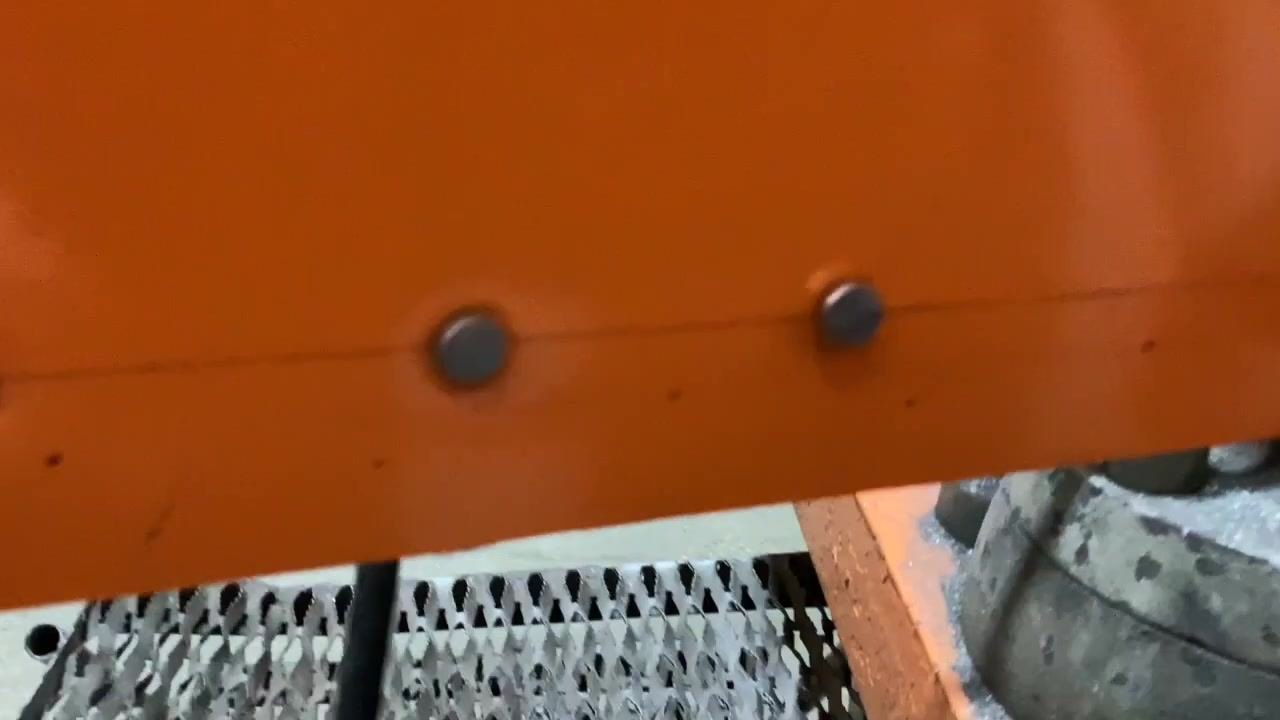 Finger pointing at a rivet that sits too close to the panel, with another rivet visible nearby.