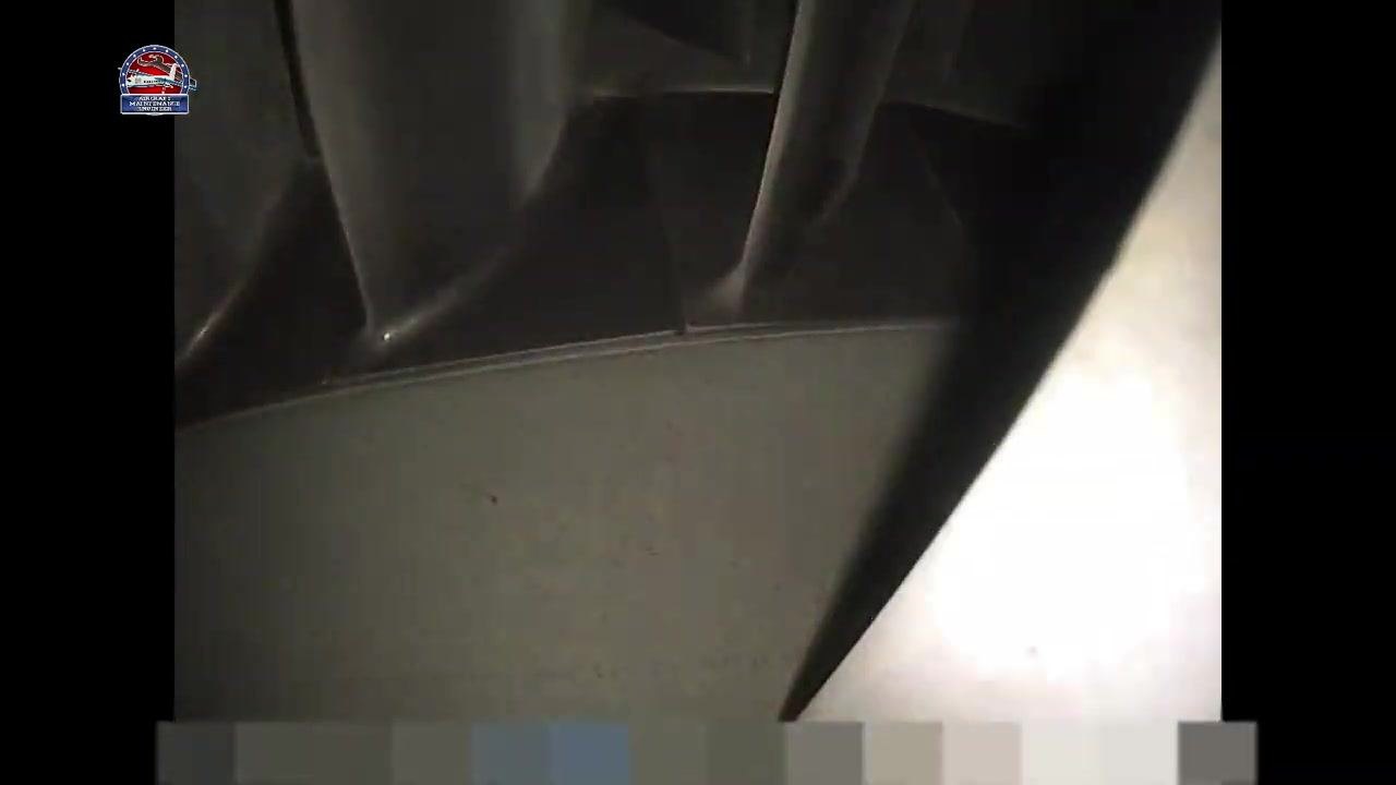 Close-up view of turbine blade roots and platform area, showing minor specks but no major defects