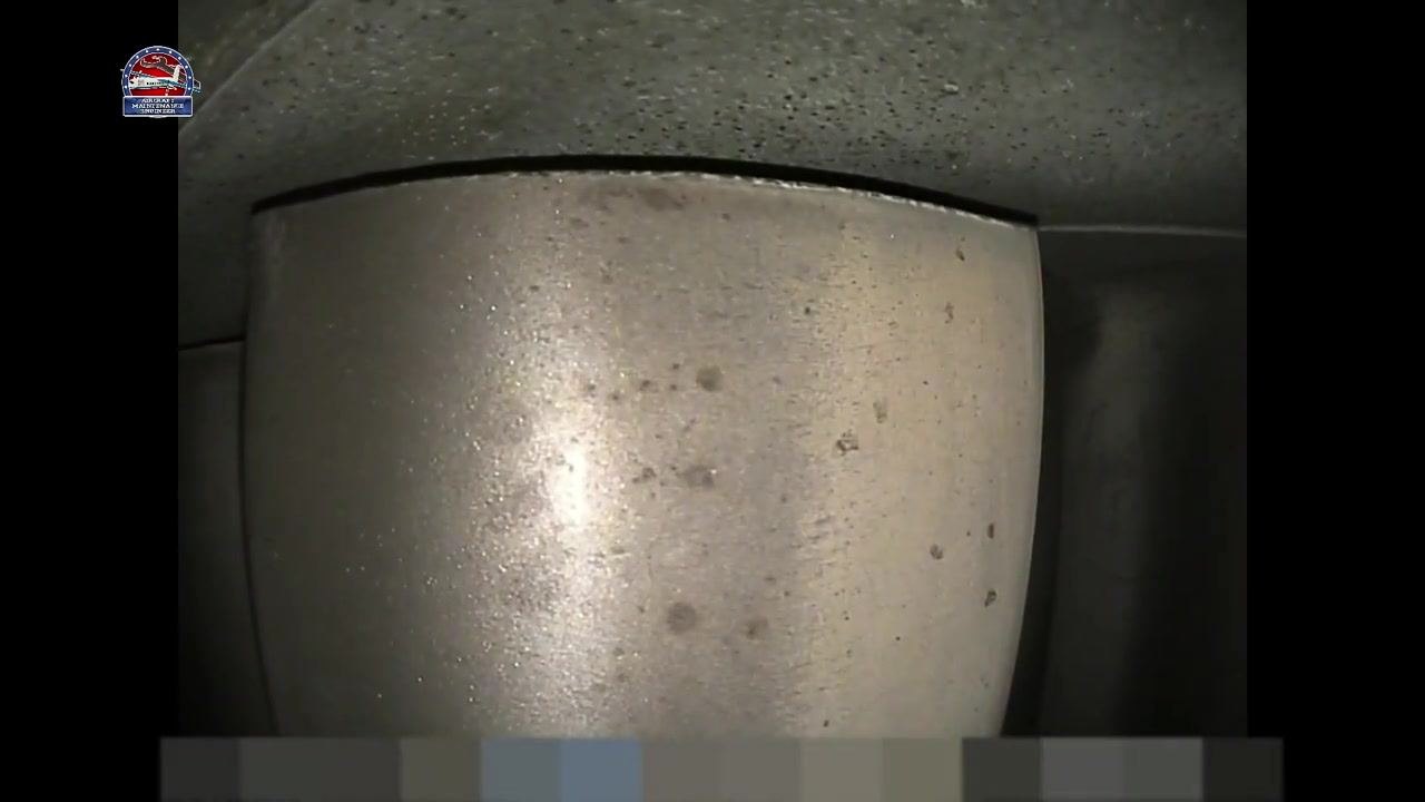 Metallic surface showing small dark spots that may indicate pitting or contamination