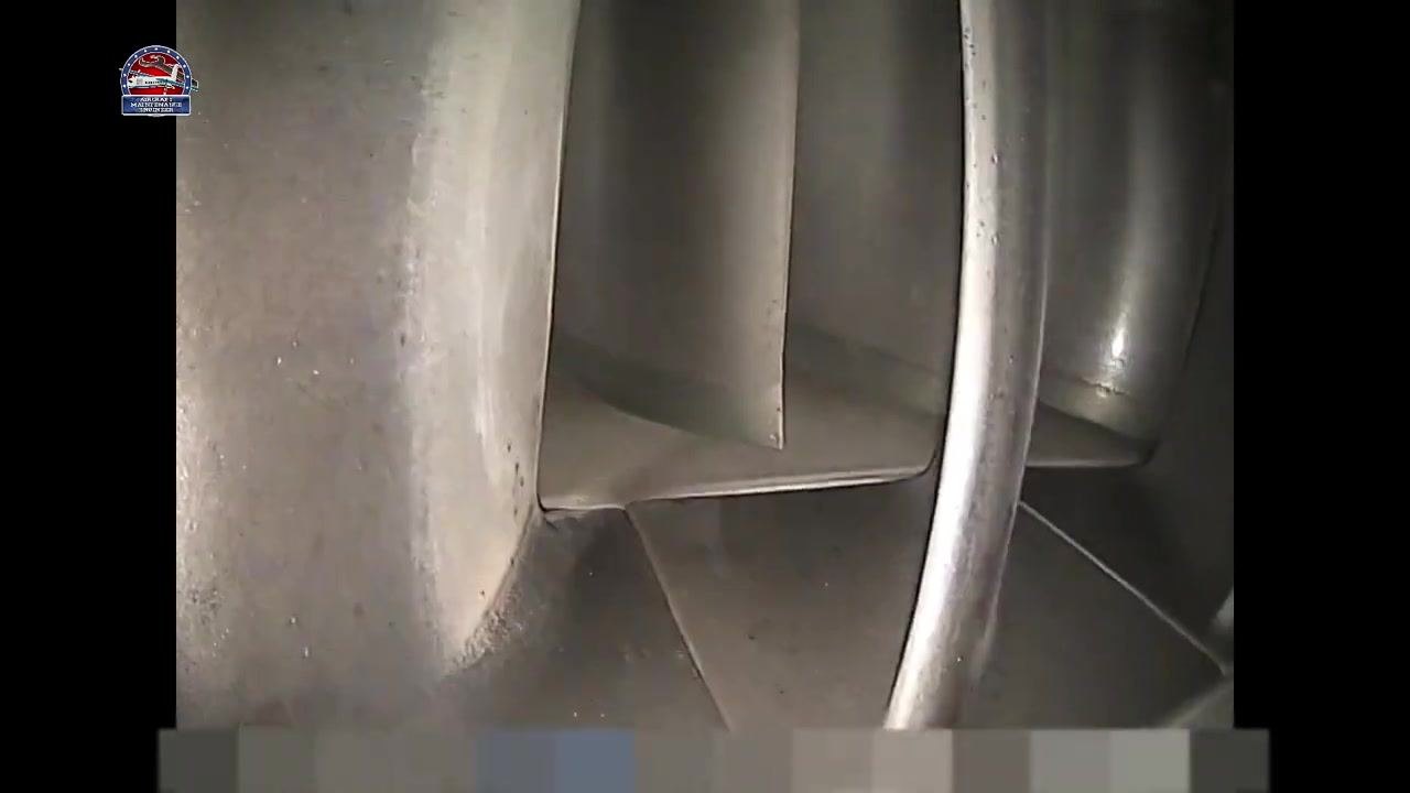 Close-up of a metallic blade surface showing texture and minor speckling with no major defects