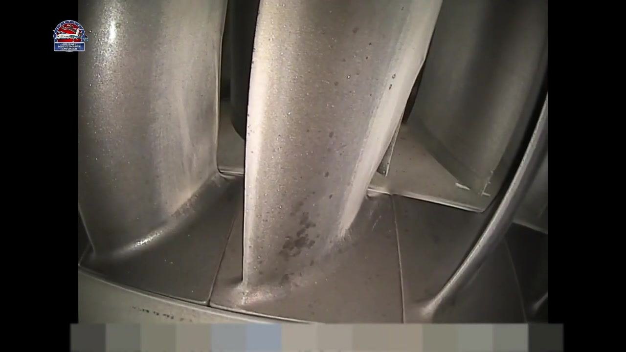 Close-up of turbine or compressor blades showing localized dark spots and surface texture