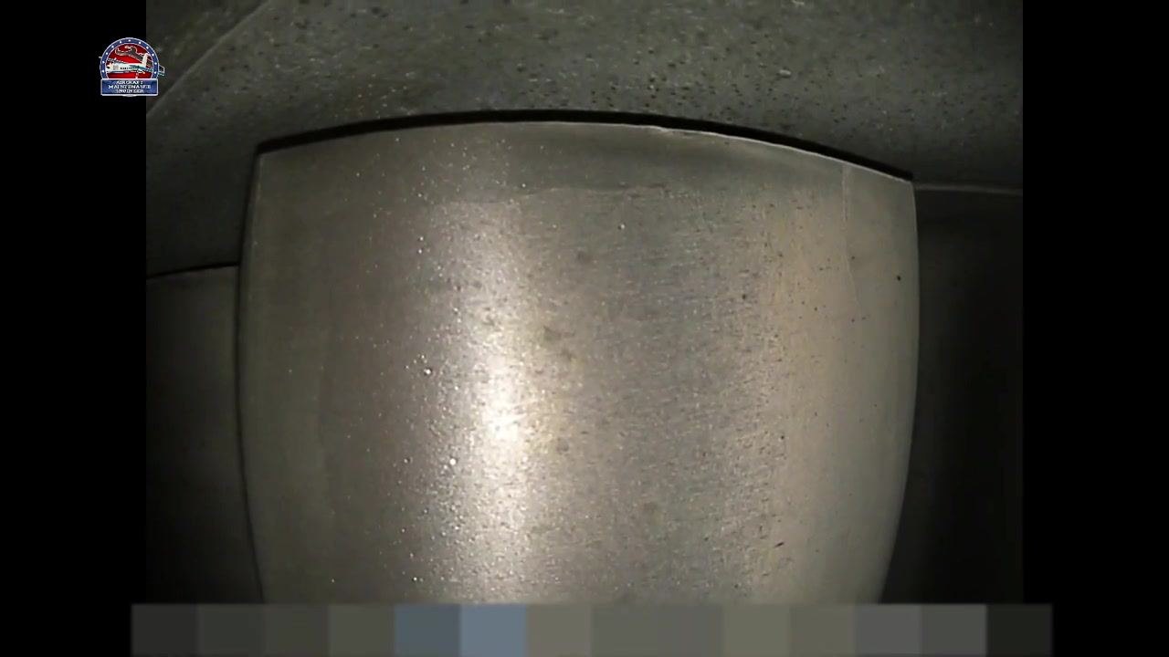 Close-up view of a metallic turbine blade with a smooth, defect-free surface, seen through the inspection camera