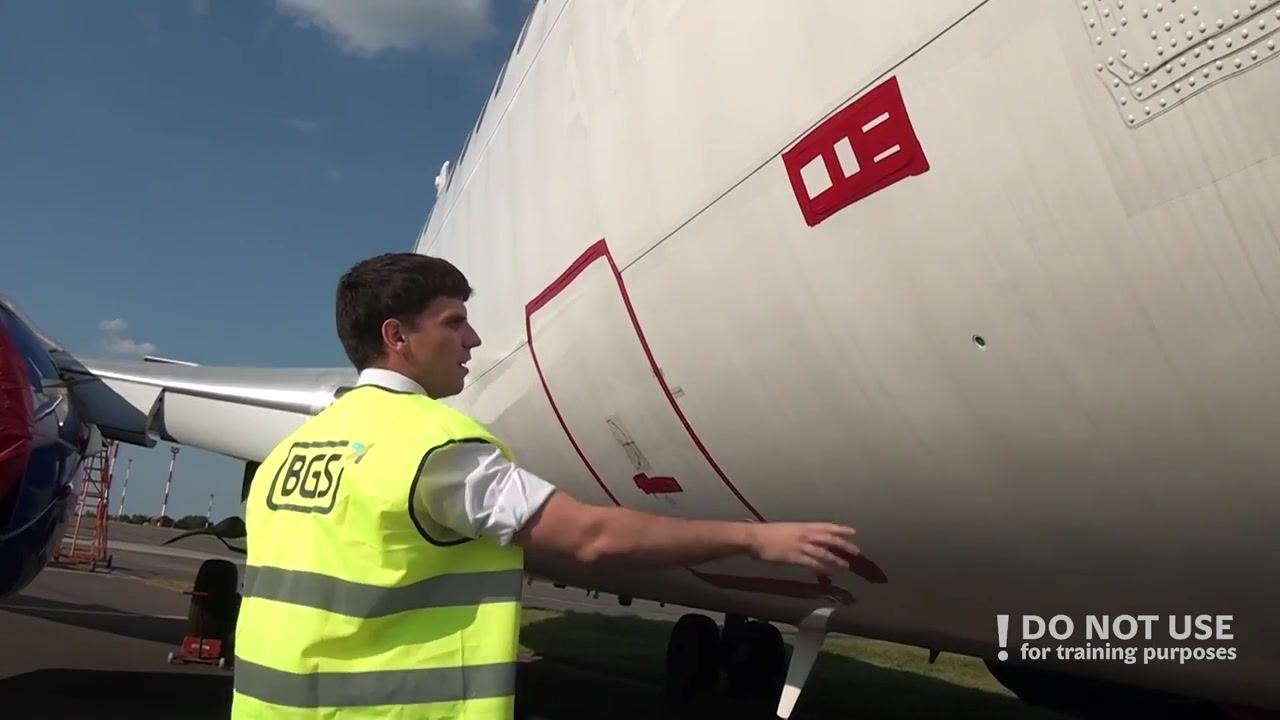 Person pointing at the pressure relief disc area on the right front fuselage, with red-outlined access panels visible.
