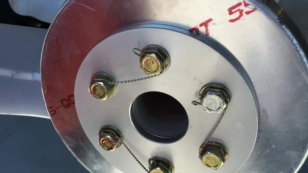 Completed safety wire installation on the propeller hub, all bolts secured, wires tight, and pigtails neatly tucked