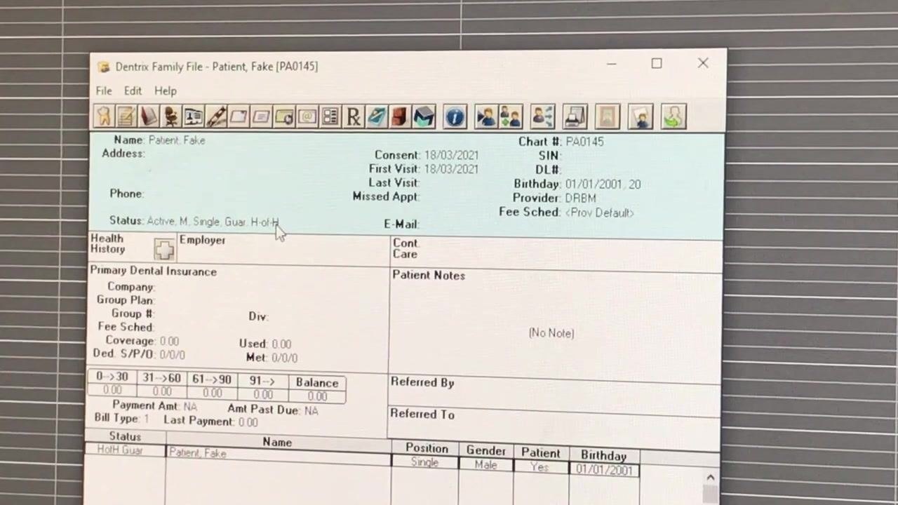 Dentrix Family File open for patient "Fake Patient" displaying demographic and insurance details, with the status field highlighted