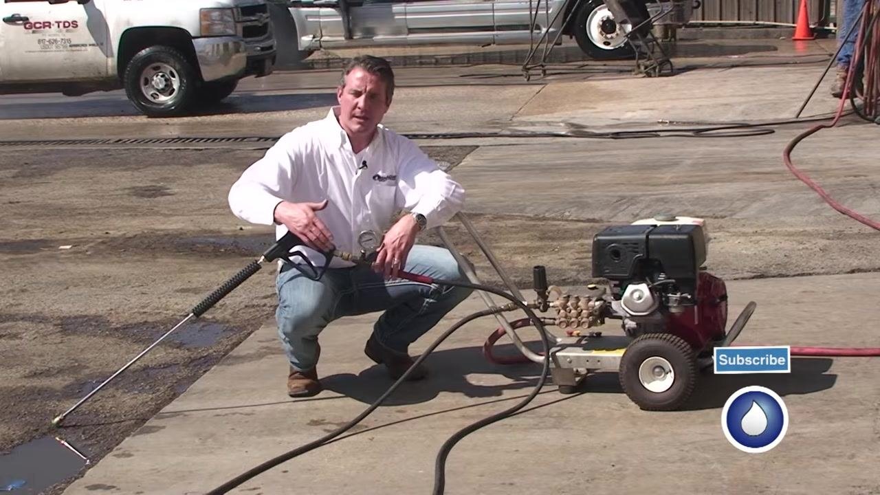 The pressure washer, hoses, and test gauge are visible while pressure loss is explained.