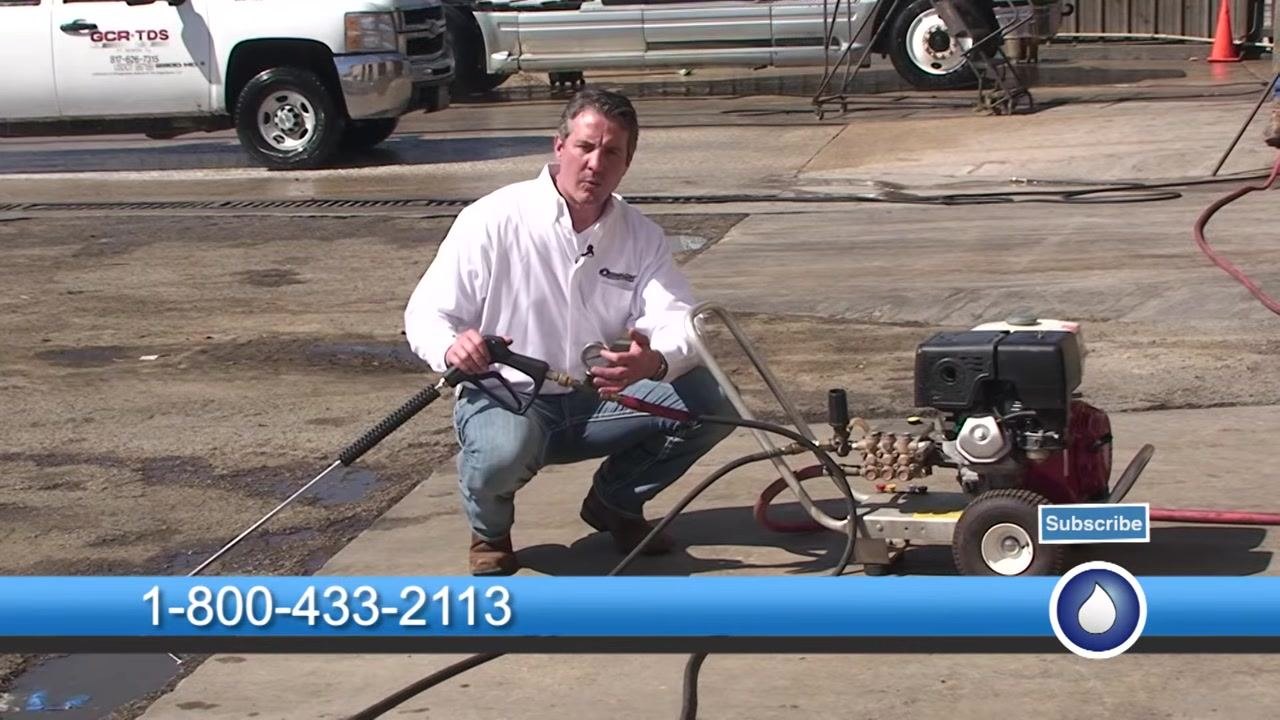 The test gauge is referenced while holding the spray gun next to the pressure washer.