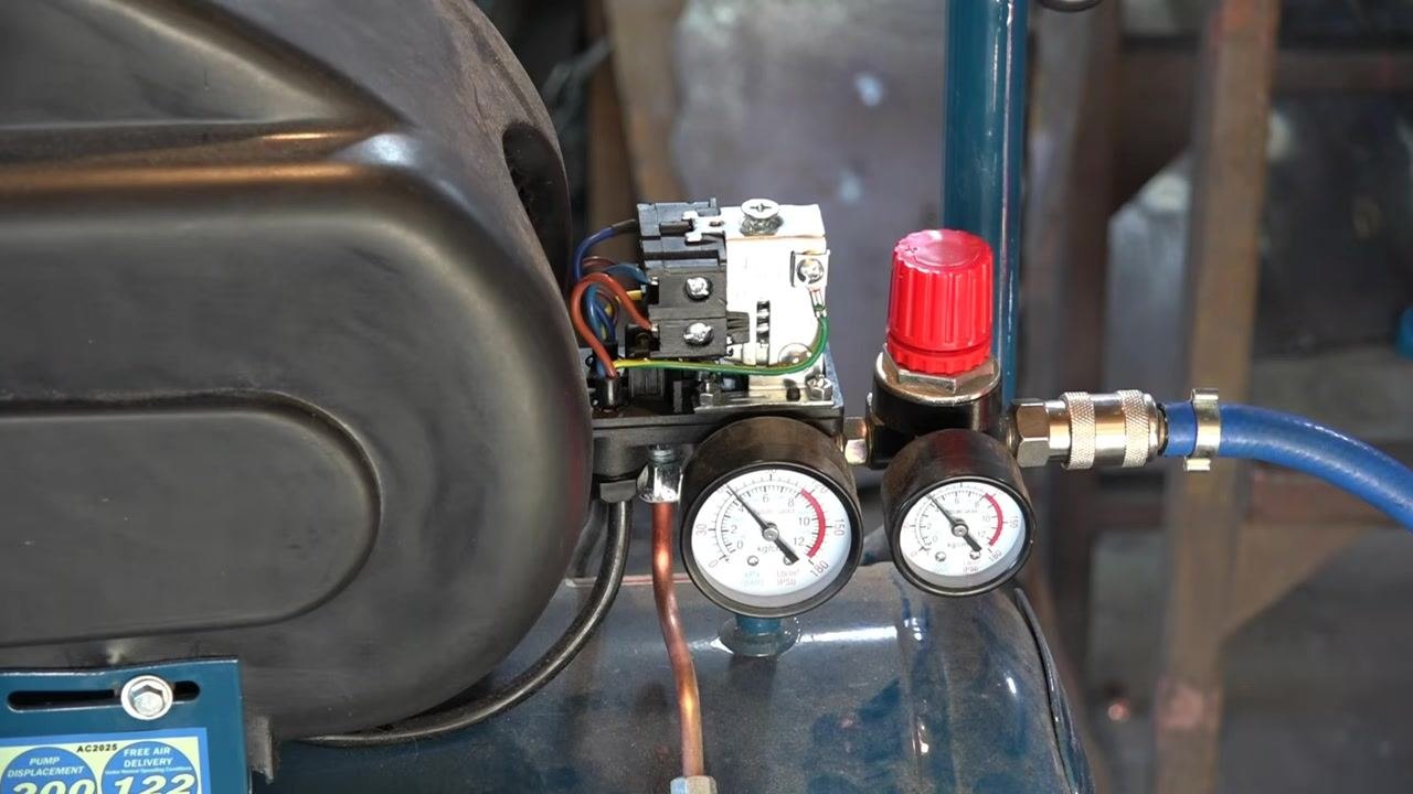 Compressor gauges showing the lowest pressure setting achieved after adjustment