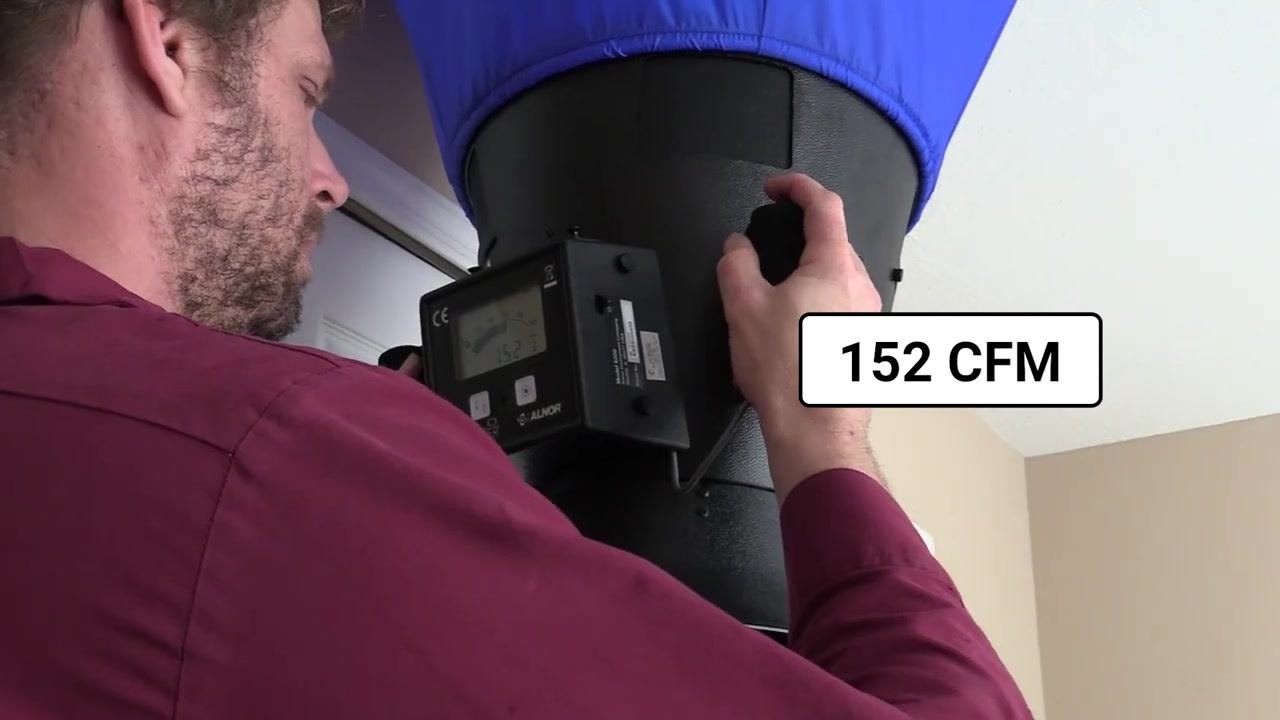 Close-up of the flow hood display showing a reading of 152 CFM.