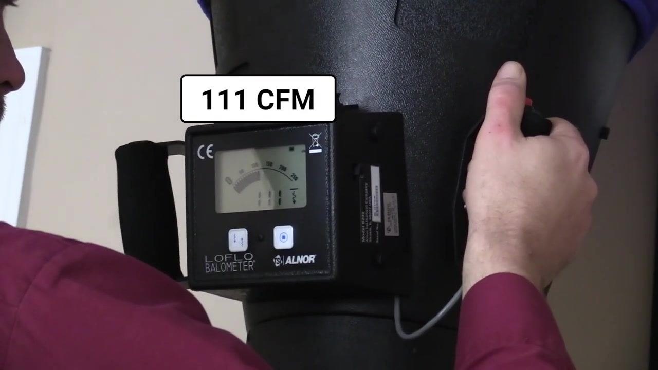 Close-up of the flow hood display showing a reading of 111 CFM.