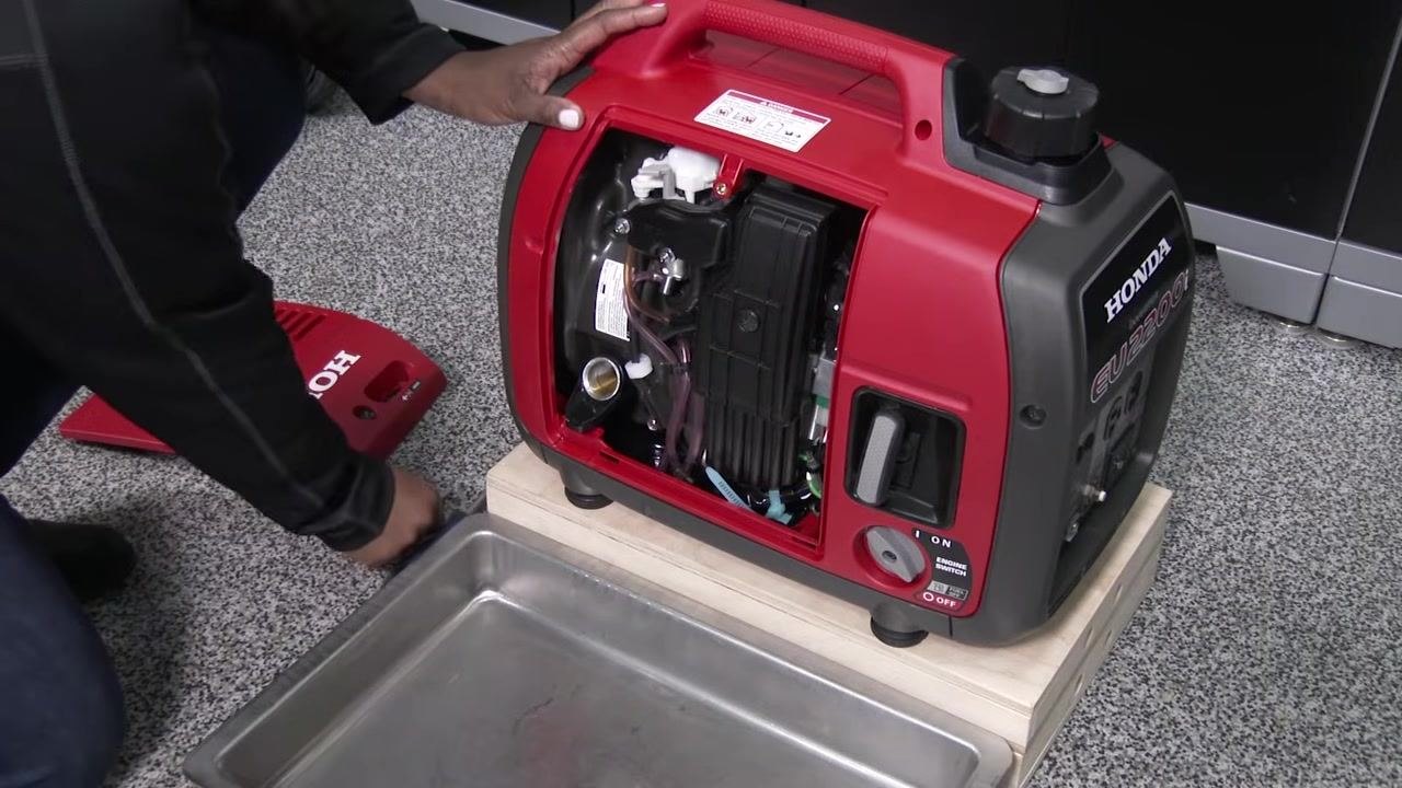 Pouring SAE 10W-30 oil into the generator using a funnel, with the oil bottle label visible