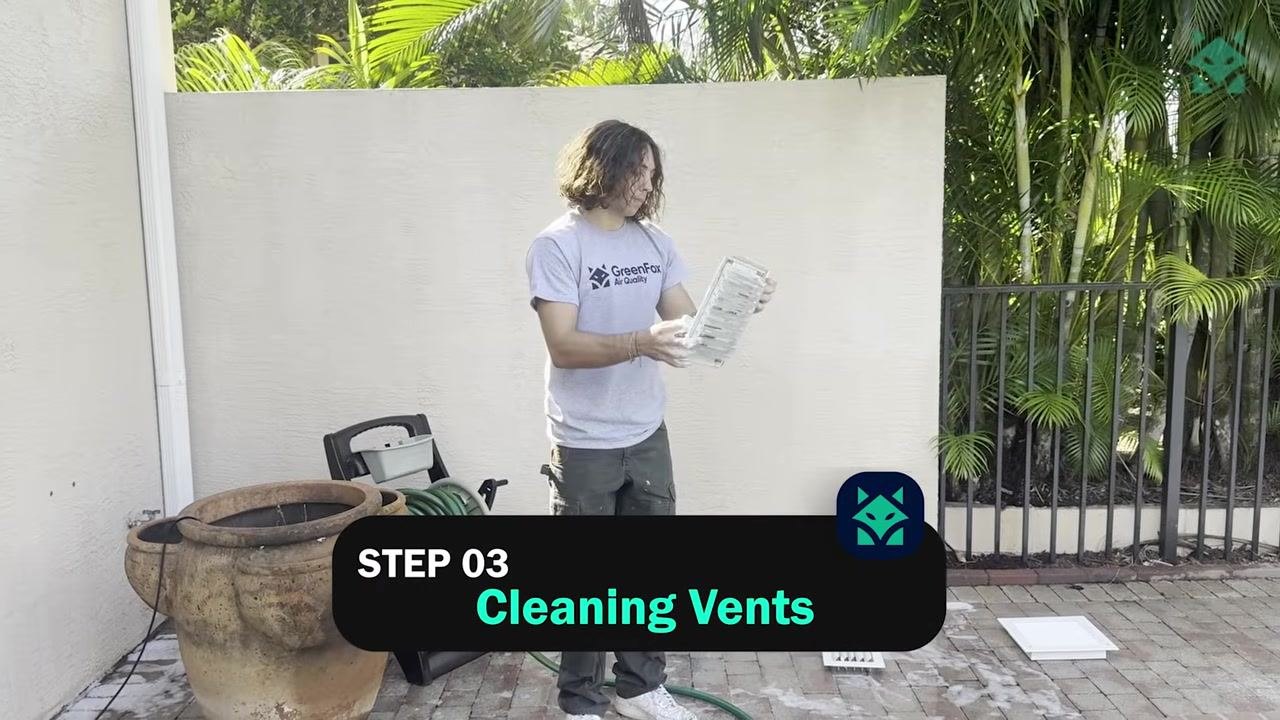 A technician in a GreenFox Air Quality shirt stands in front of a house, with the on-screen label "STEP 01 Floor Protection & Covering".