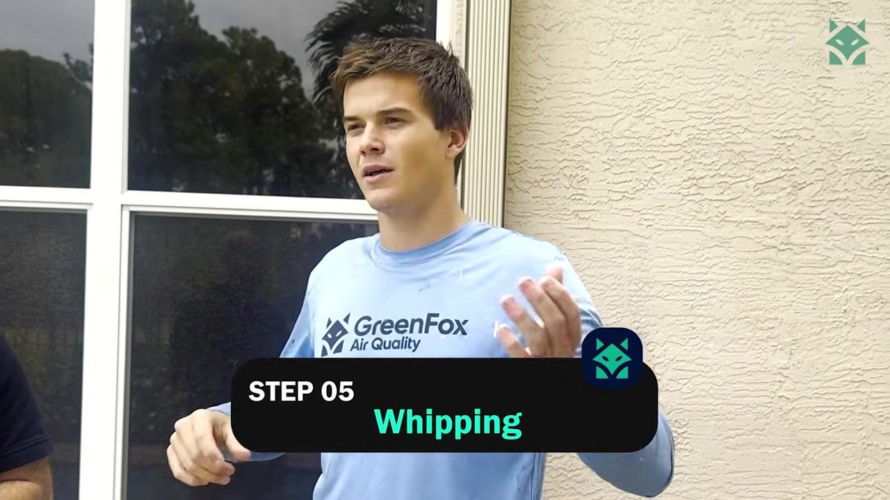 A technician in a GreenFox Air Quality shirt, with the on-screen label "STEP 05 Whipping".