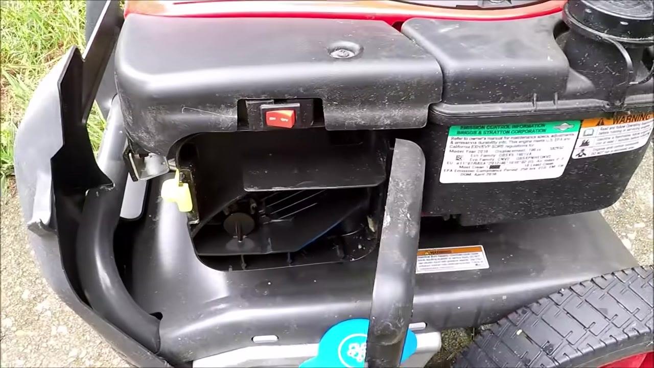 Close-up of the air filter housing with the ON/OFF switch and surrounding labels visible, air filter door removed.