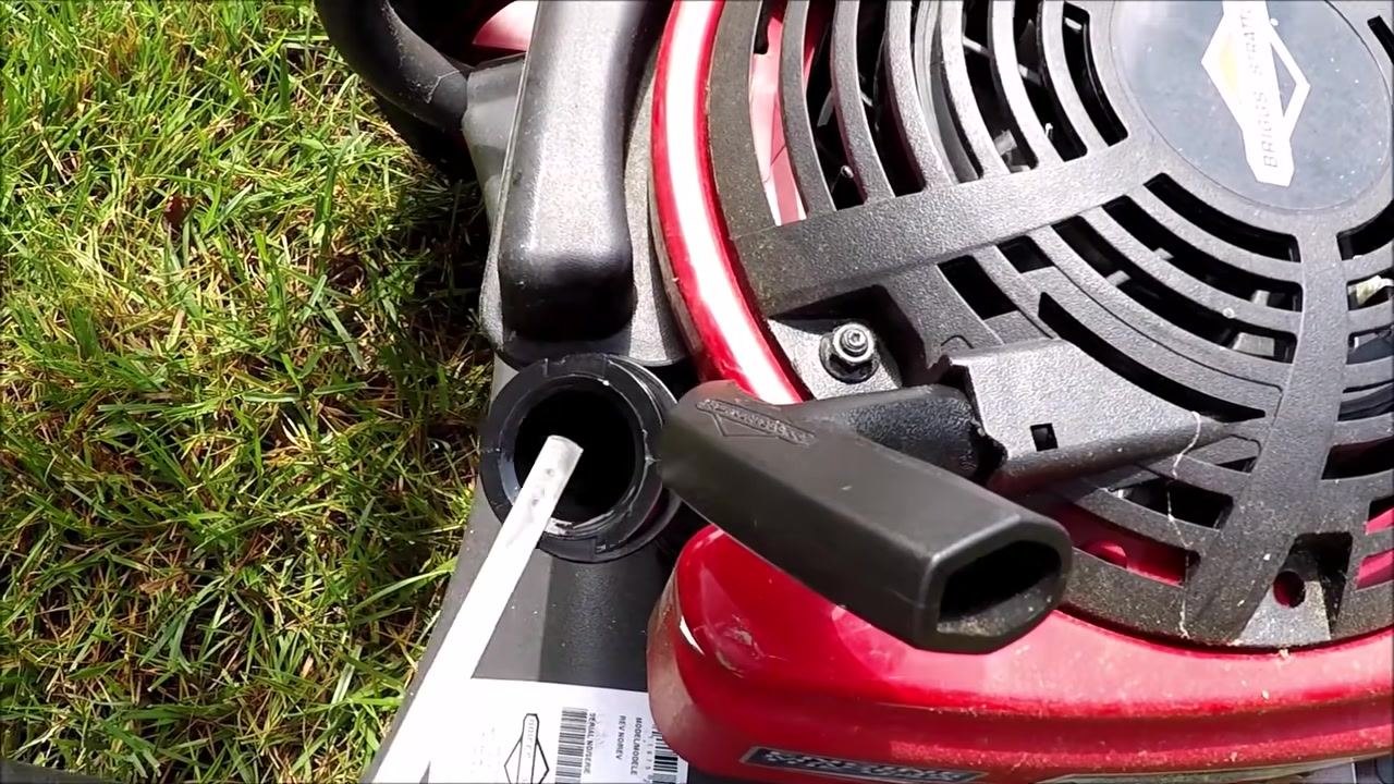 Close-up of the oil fill opening and dipstick, showing the oil level and engine housing details.