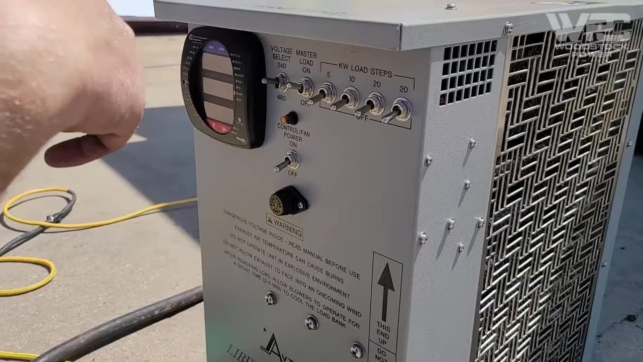 Technician pointing at the generator breaker panel, emphasizing cable connections and workspace cleanliness