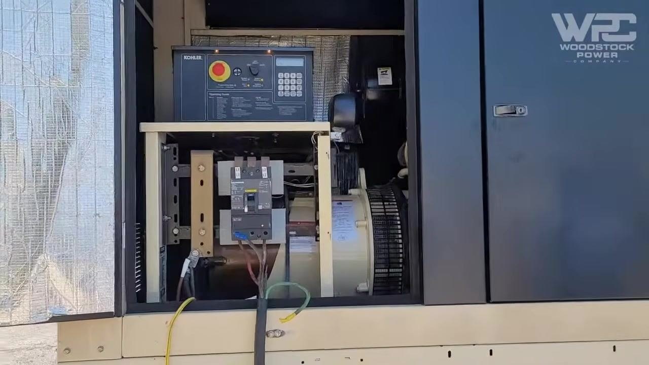 Load bank on the ground with visible heavy-duty cables, ground wire, and connectors