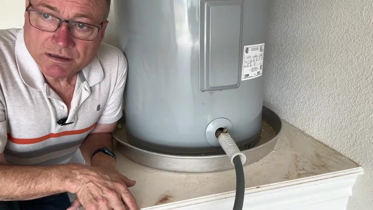 Water heater draining with hose attached, with a text overlay indicating that 20 minutes have passed