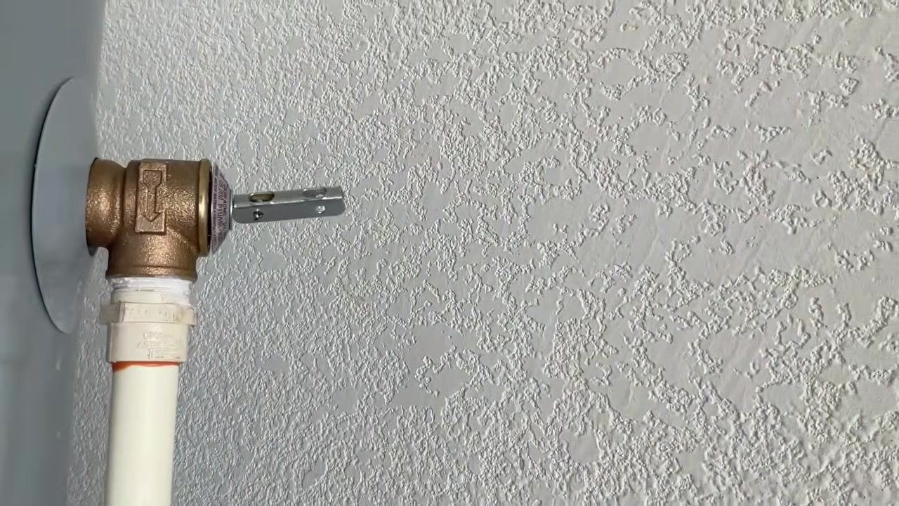 Close-up of the temperature and pressure relief valve on the side of the water heater