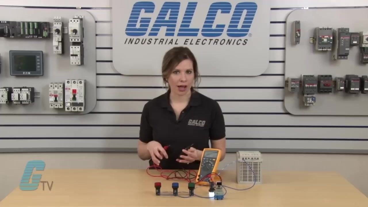 Multimeter input ports showing the red lead inserted in the "10A" port and the black lead in the "COM" port, with labels for voltage, resistance, and current visible.