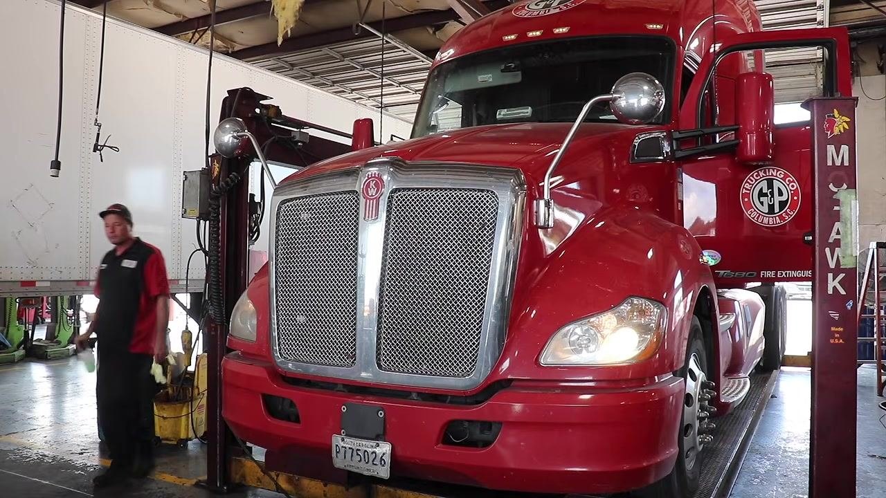 Technician inspecting inside a compartment, checking the fire extinguisher and emergency equipment.