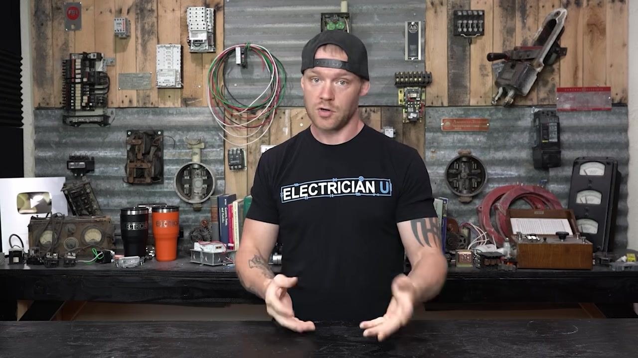 Presenter emphasizing troubleshooting steps for shunt trip breakers, leaning forward with hands gesturing
