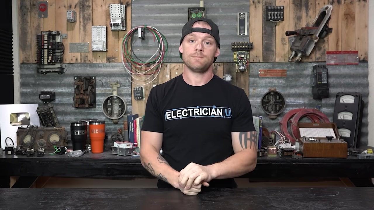 Presenter explaining that a faulty breaker needs replacement, hands clasped in front