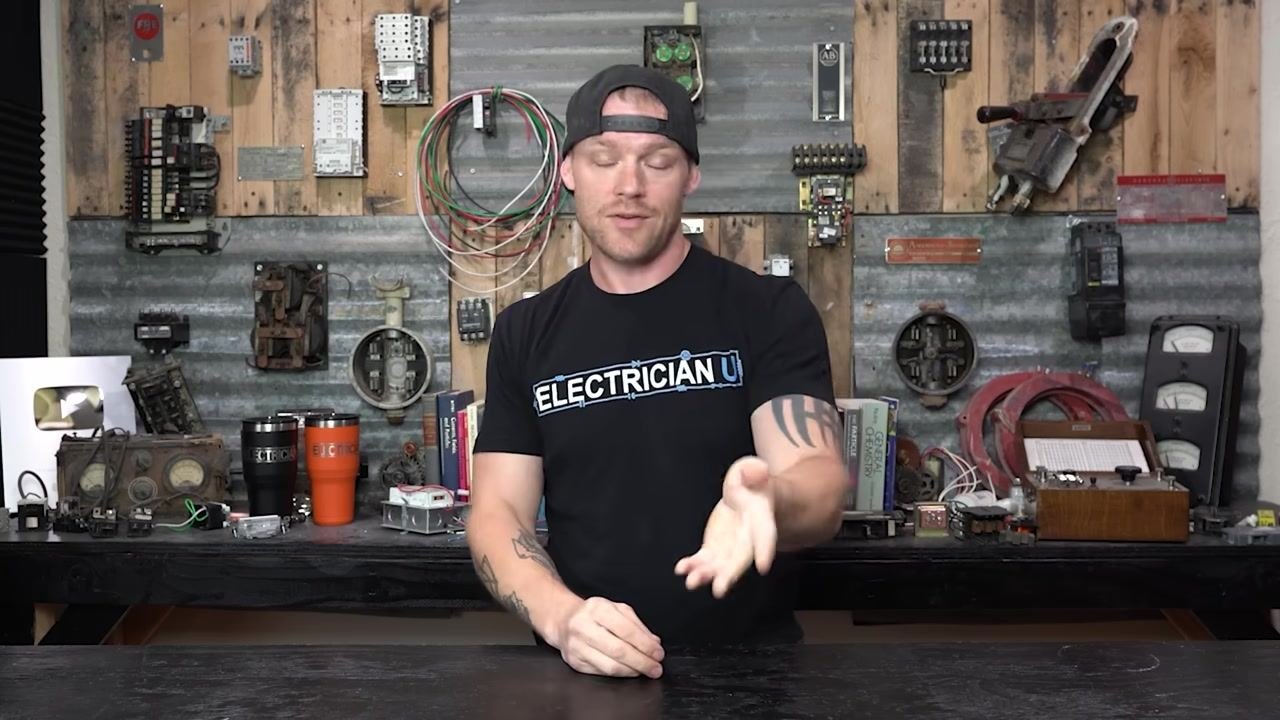 Presenter pointing downward, discussing failures in contactors and relays