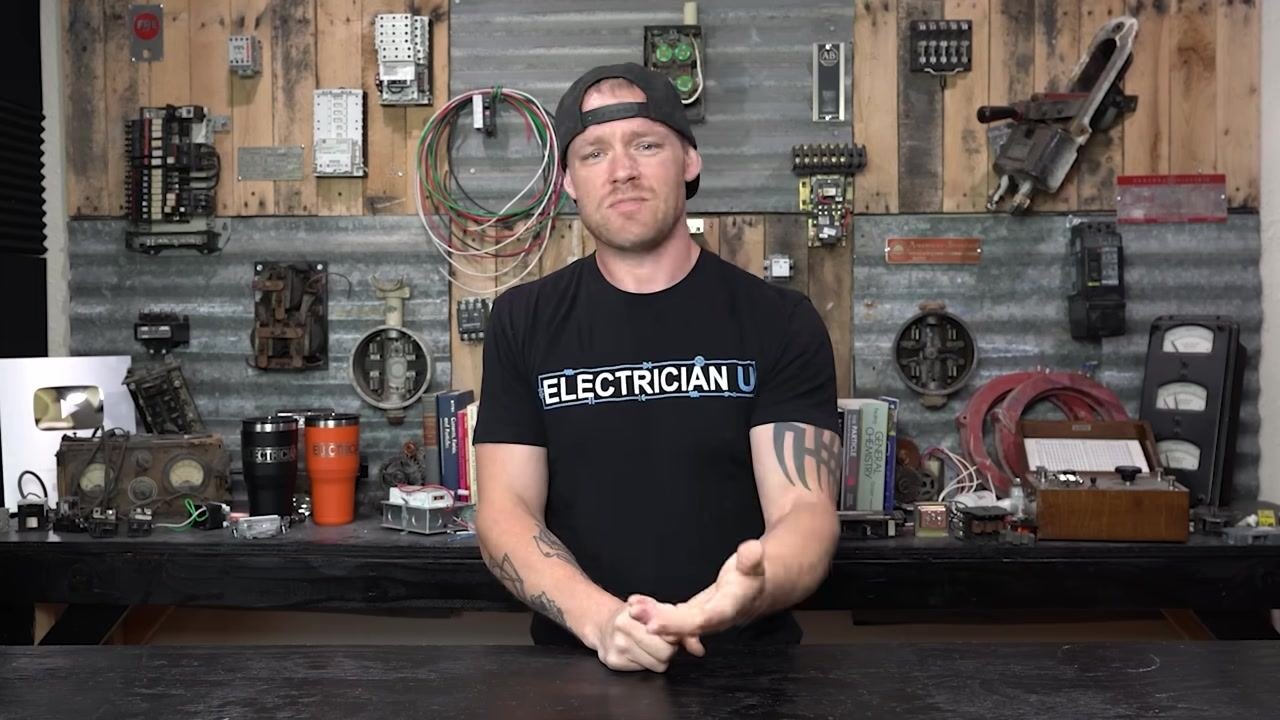 Presenter gesturing with one hand, warning about the risks of single-phasing a three-phase load