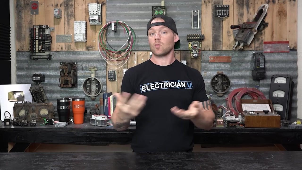 A person in a workshop, gesturing with hands, describing breakers that fail to reset or trip immediately even with no load.