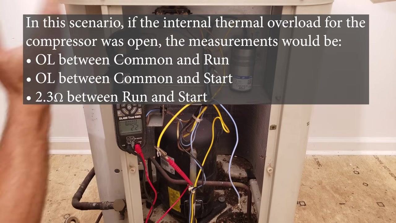 Compressor cabinet open with a digital multimeter connected and wiring visible