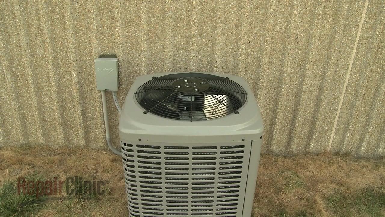 Outdoor central air conditioning unit next to a wall, a typical location for a capacitor