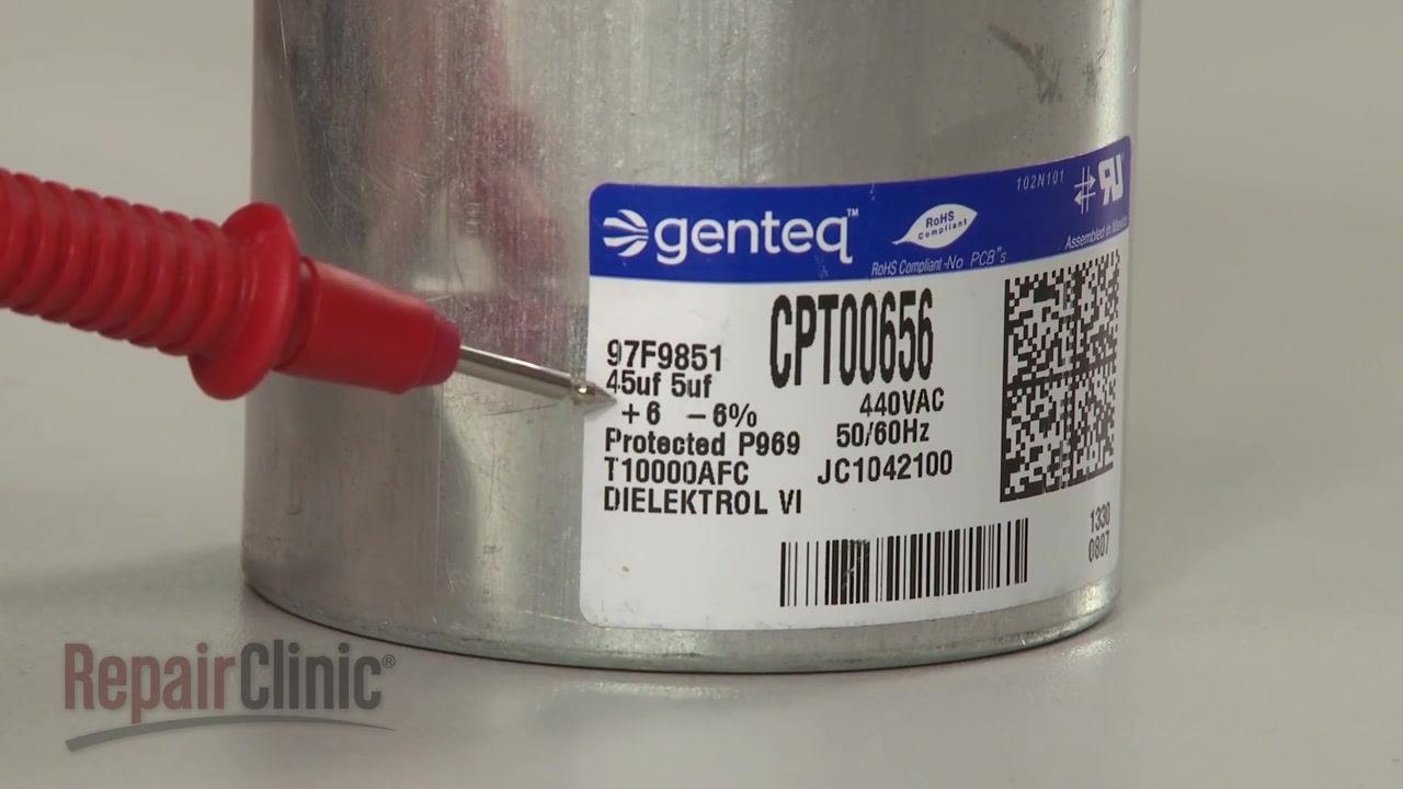 Close-up of a dual capacitor label showing "45uf 5uf" ratings, with a probe pointing at the values