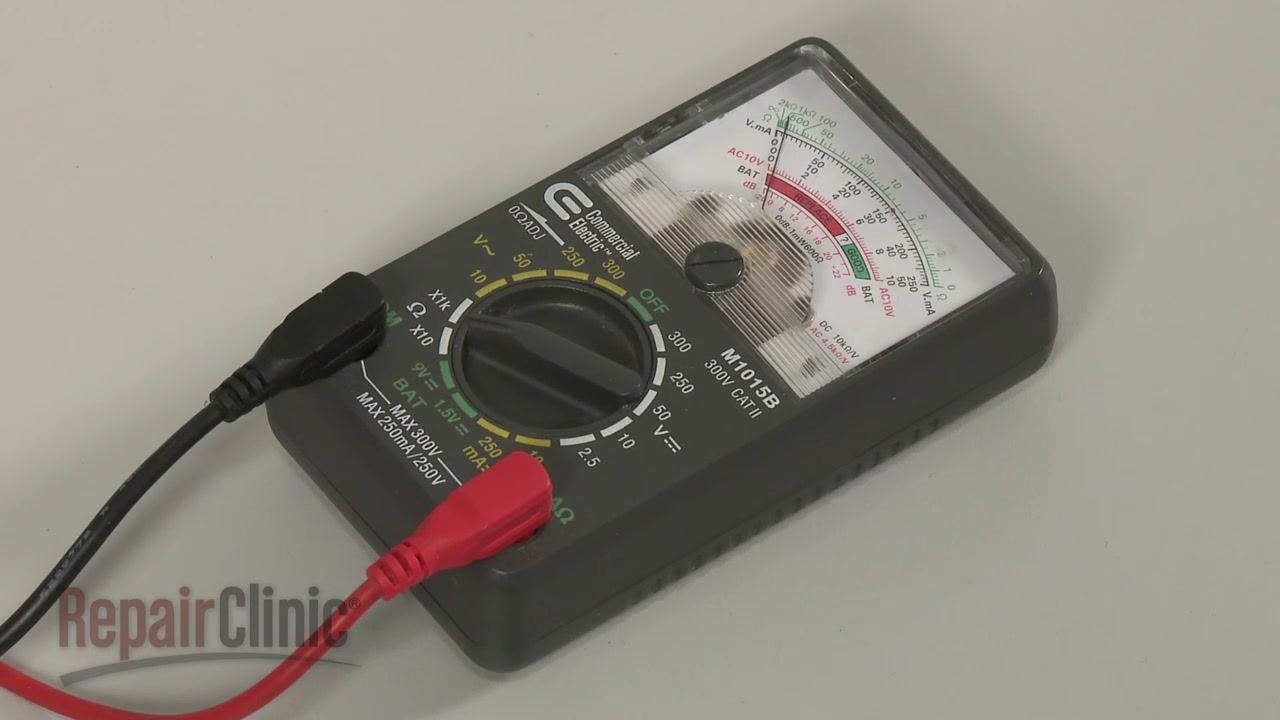 Analog ohm meter with dial set, red and black probes attached