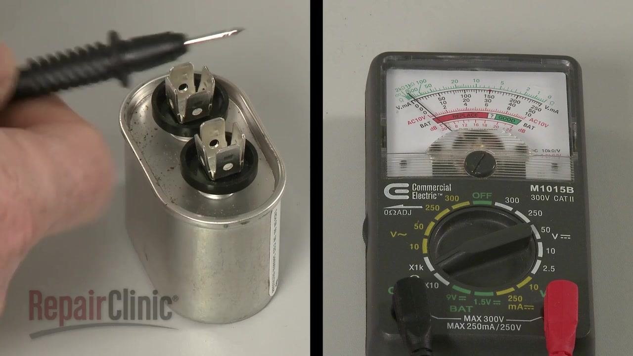Split image: a hand holding a probe near the capacitor terminals on the left, and the ohm meter showing needle deflection on the right