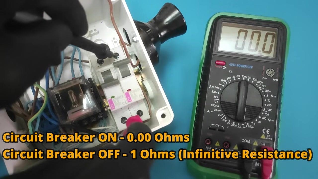 Gloved hands using multimeter probes on a circuit breaker; the digital multimeter display shows 00.0, with on-screen text summarizing the expected readings for the ON and OFF states