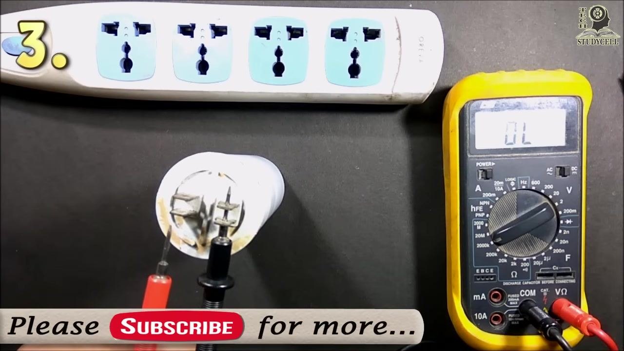 The swapped probes connected to the capacitor, with the multimeter display reading "OL"