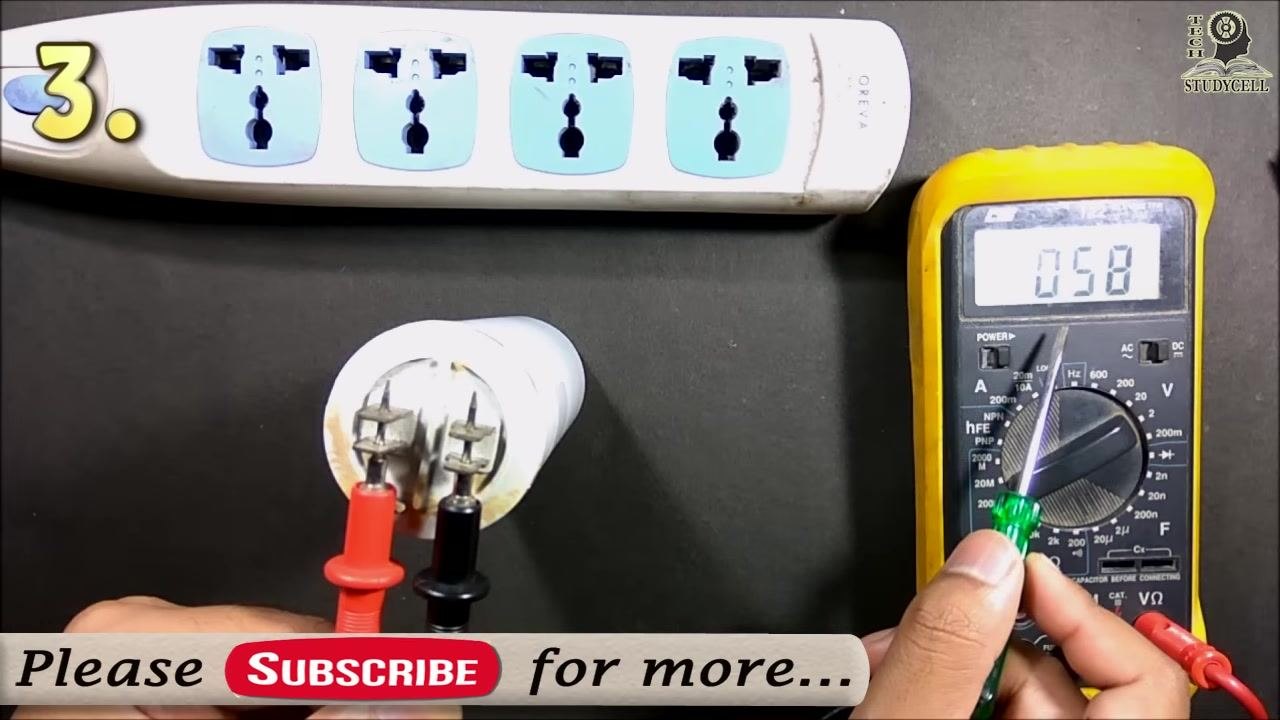 The multimeter showing "058," with a hand holding a screwdriver near the terminals