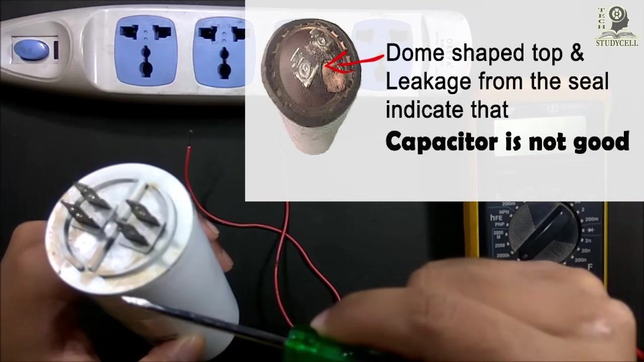 A screwdriver pointing at the capacitor label, showing all technical specifications