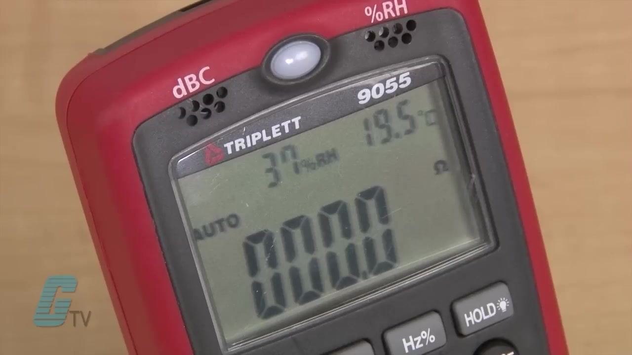 Close-up of a digital multimeter (TRIPLETT 9055) showing a resistance reading of 0.000 ohms, indicating the probes are touching and the circuit is closed.