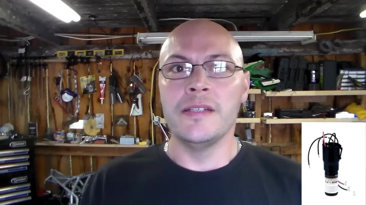 Holding a replacement relay for the compressor, workshop background with tools and shelves