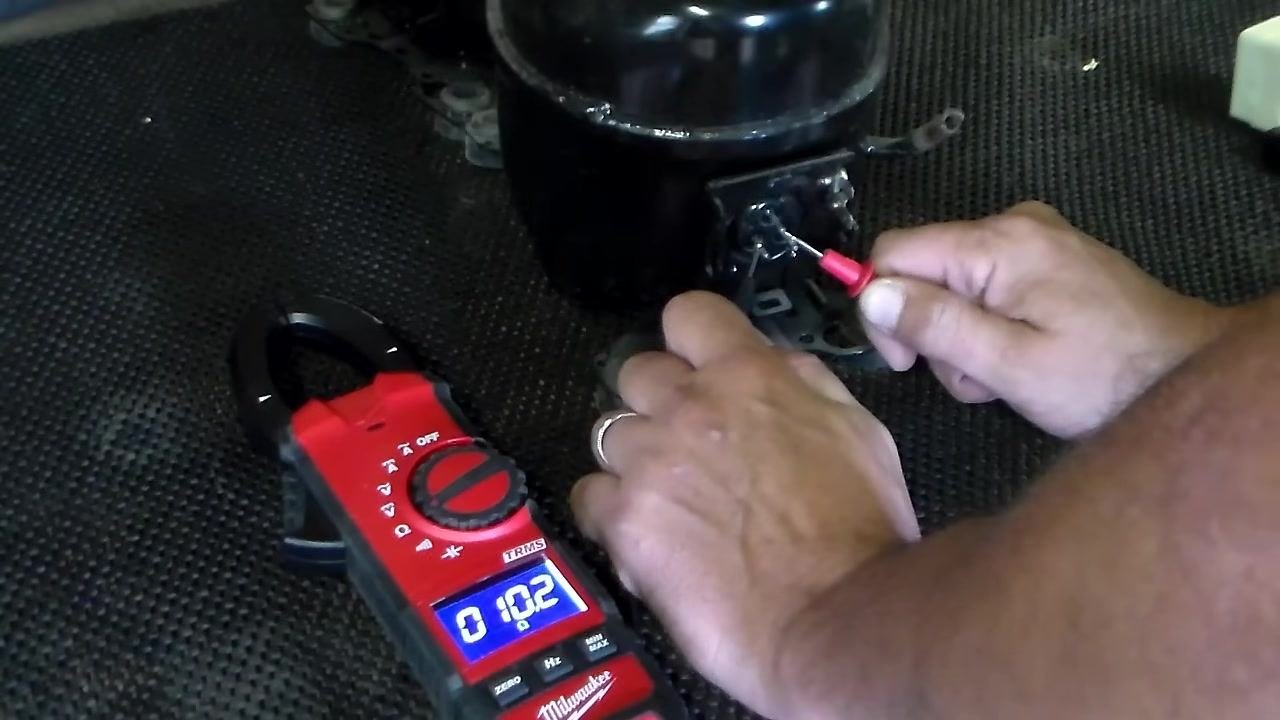 Measuring resistance from the top terminal to the bottom left terminal; multimeter displays 6 ohms