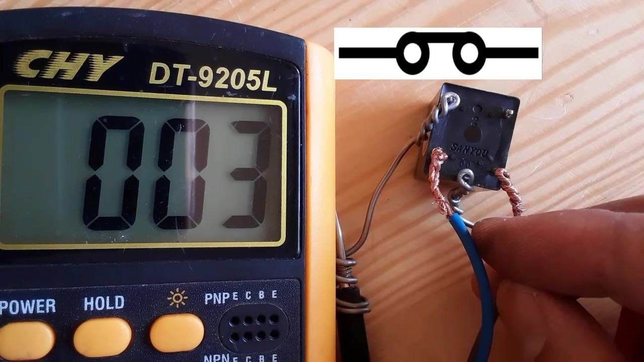 Multimeter (CHY DT-9205L) displays "003," relay module with wires, schematic symbol for a closed switch, hand holding a blue wire on a wooden surface