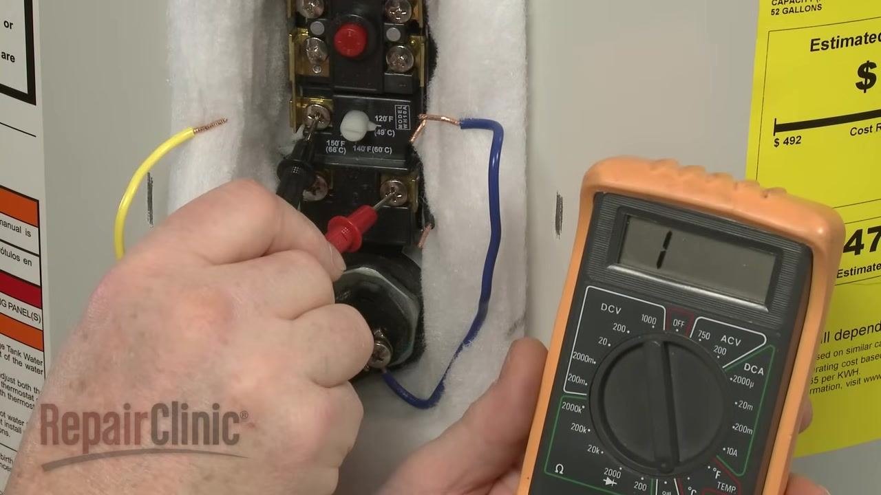 Digital multimeter showing 006 ohms, probes touching the common and upper heating element terminals on the thermostat