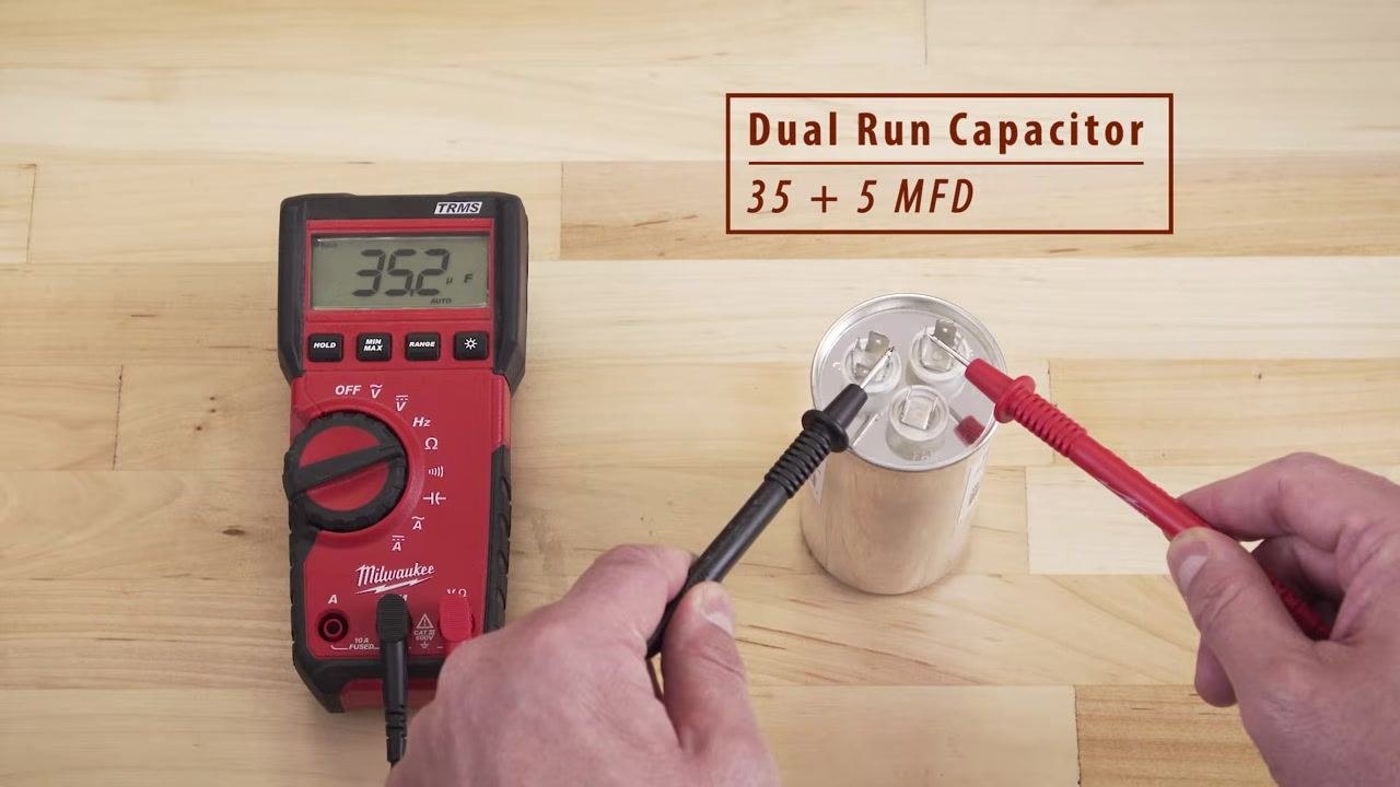 Multimeter showing 35.2 μF while testing between the Herm and Common terminals on a dual run capacitor labeled 35 + 5 MFD