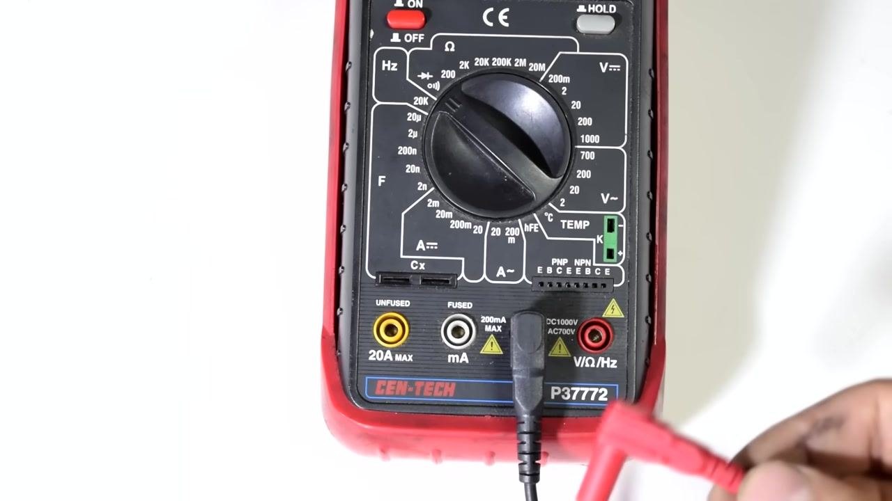 Multimeter and test leads connected to a wire harness with multiple connectors, suitable for various circuit sizes.