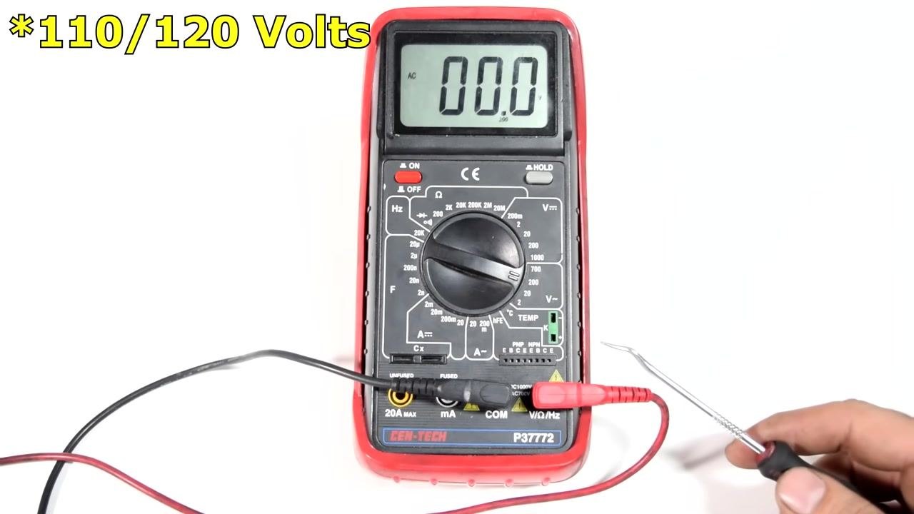 Close-up of the multimeter dial, with a metal pointer indicating the AC voltage section (V~) at the 200V setting.