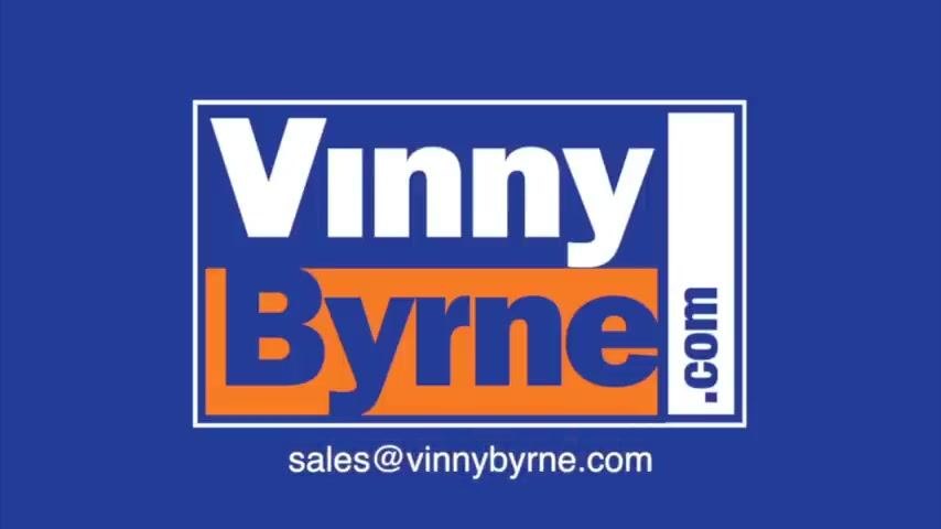 Vinny Byrne logo and website displayed on a blue background. No other objects or people are visible.