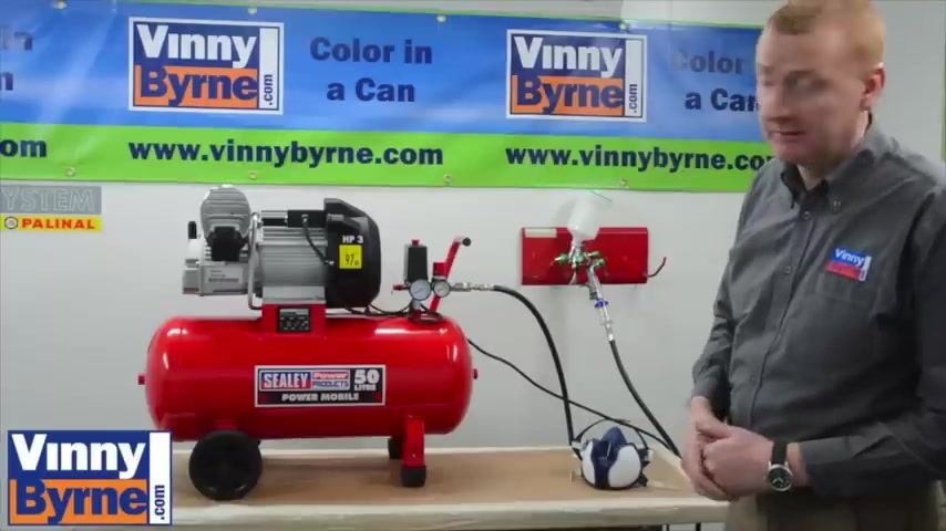 Compressor and spray gun setup shown alongside other equipment