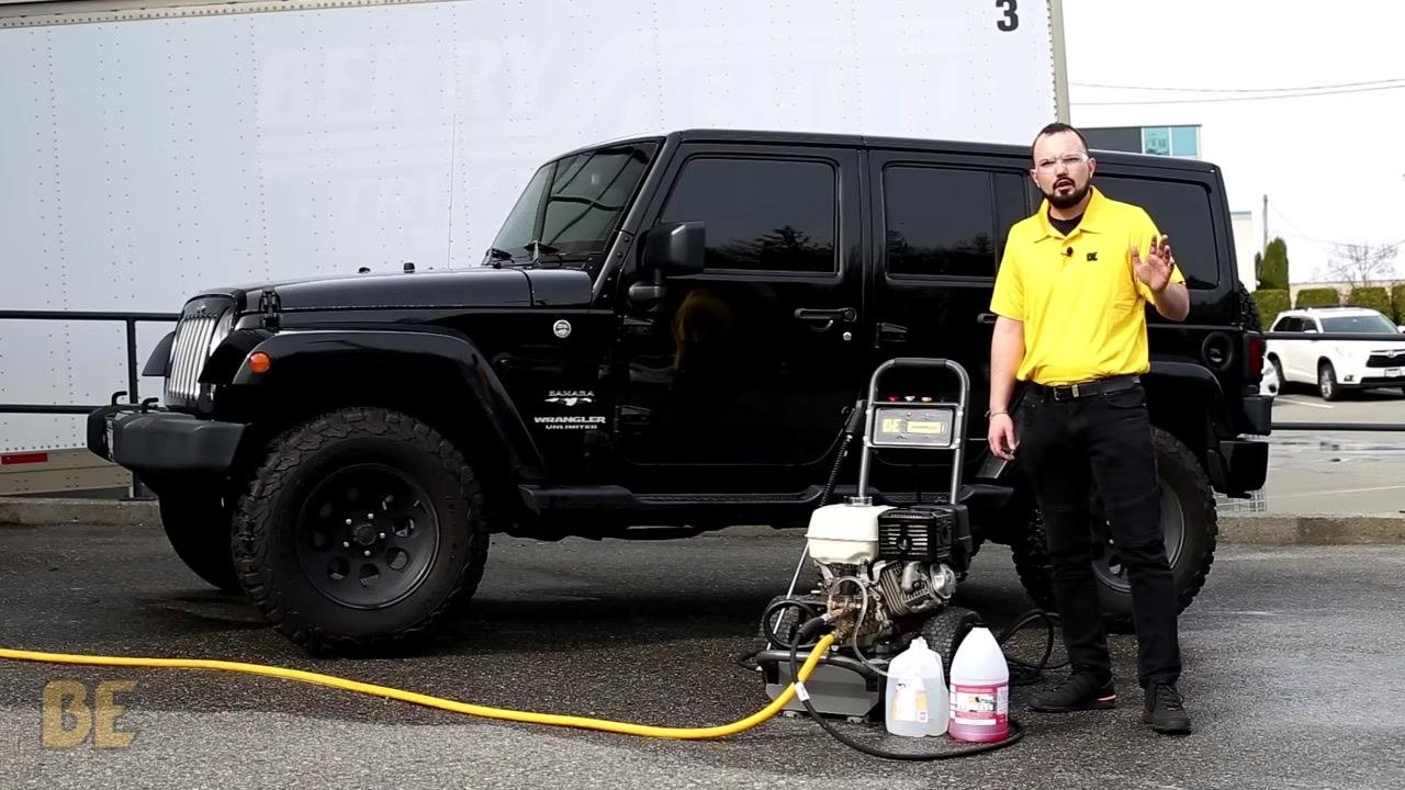 Person in yellow shirt standing next to the BE Power Washer and Jeep, waving and providing closing remarks. The BE Power Equipment logo is visible on the shirt.